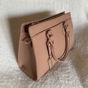 Miztique handbag with three pockets. Neutral color to match any outfit